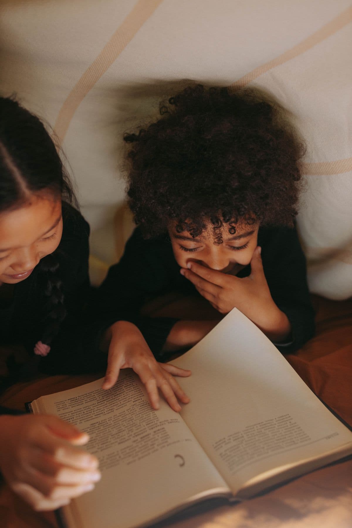 Two children reading together at an ARISE session